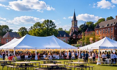 Several tents with picnic tables at a town festival